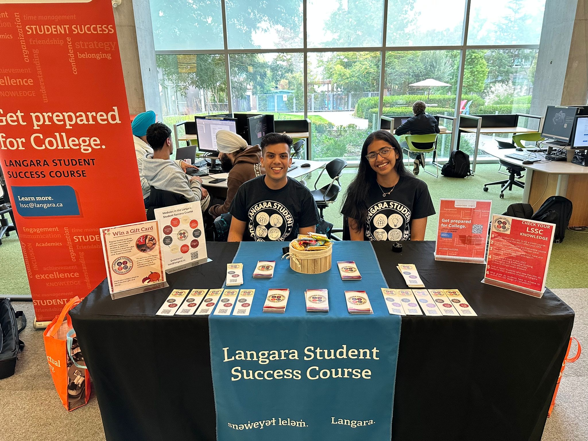 Vansh and fellow volunteer Urvi working at a table in the library.