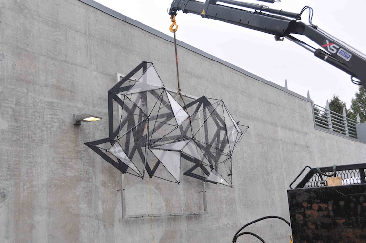 The sculpture is hung outside of the 49th Avenue Canada Line Station