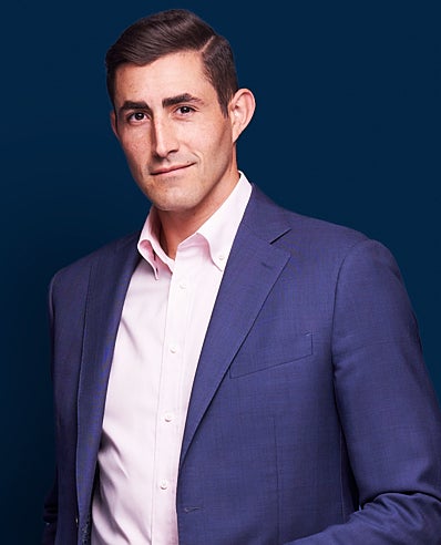 Photo of Nick Smith in a blue sports coat. He has dark hair.