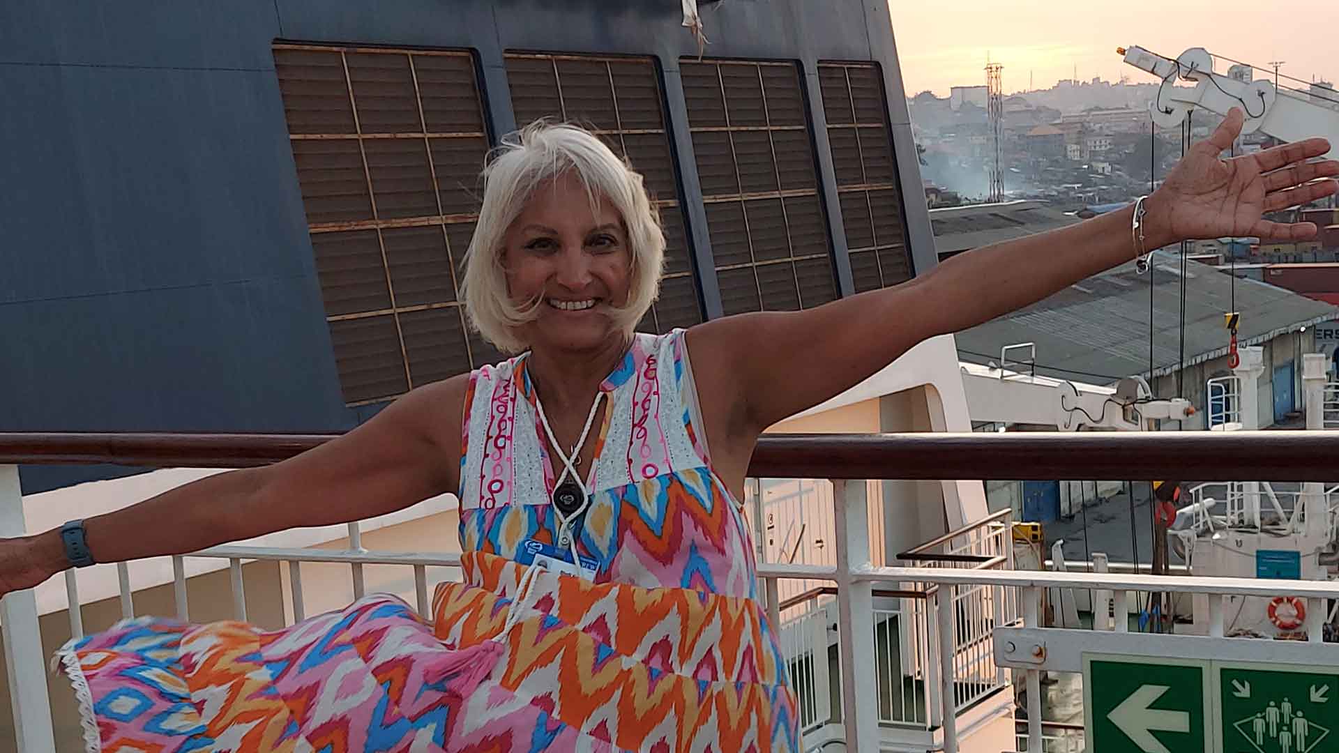 Nursing instructor Shelina Keys is standing at the entrance of a Mercy Ship Canada, where she volunteers providing essential healthcare in Senegal and Sierra Leone.