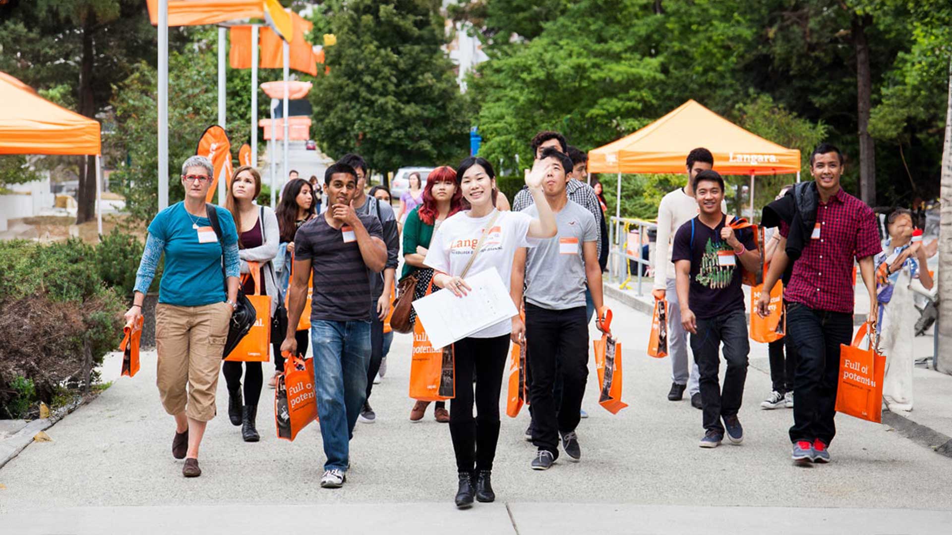 A recruitment person is showing the college to future students.