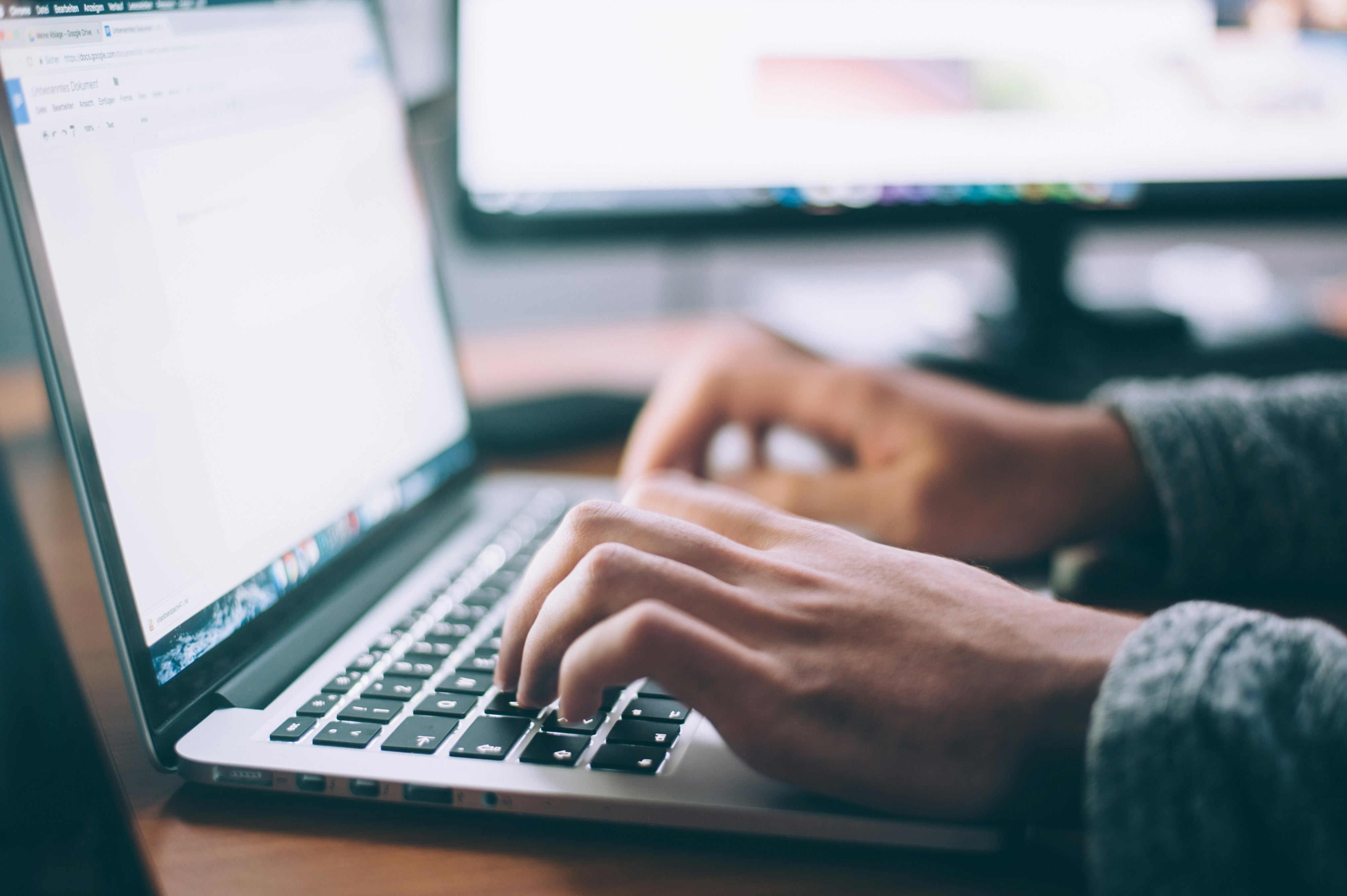 stock image of typing on a laptop