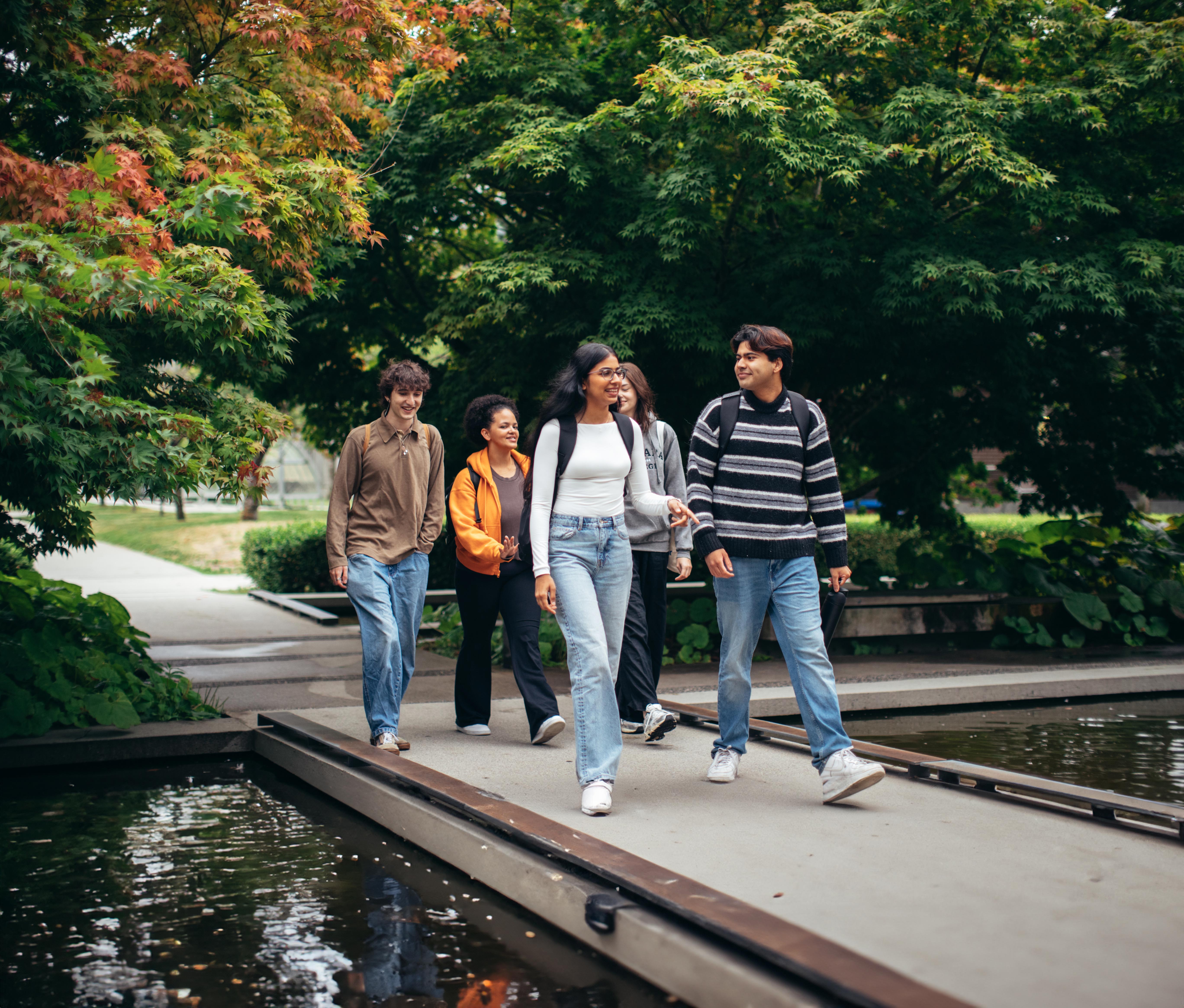 Students crossing the campus pond.