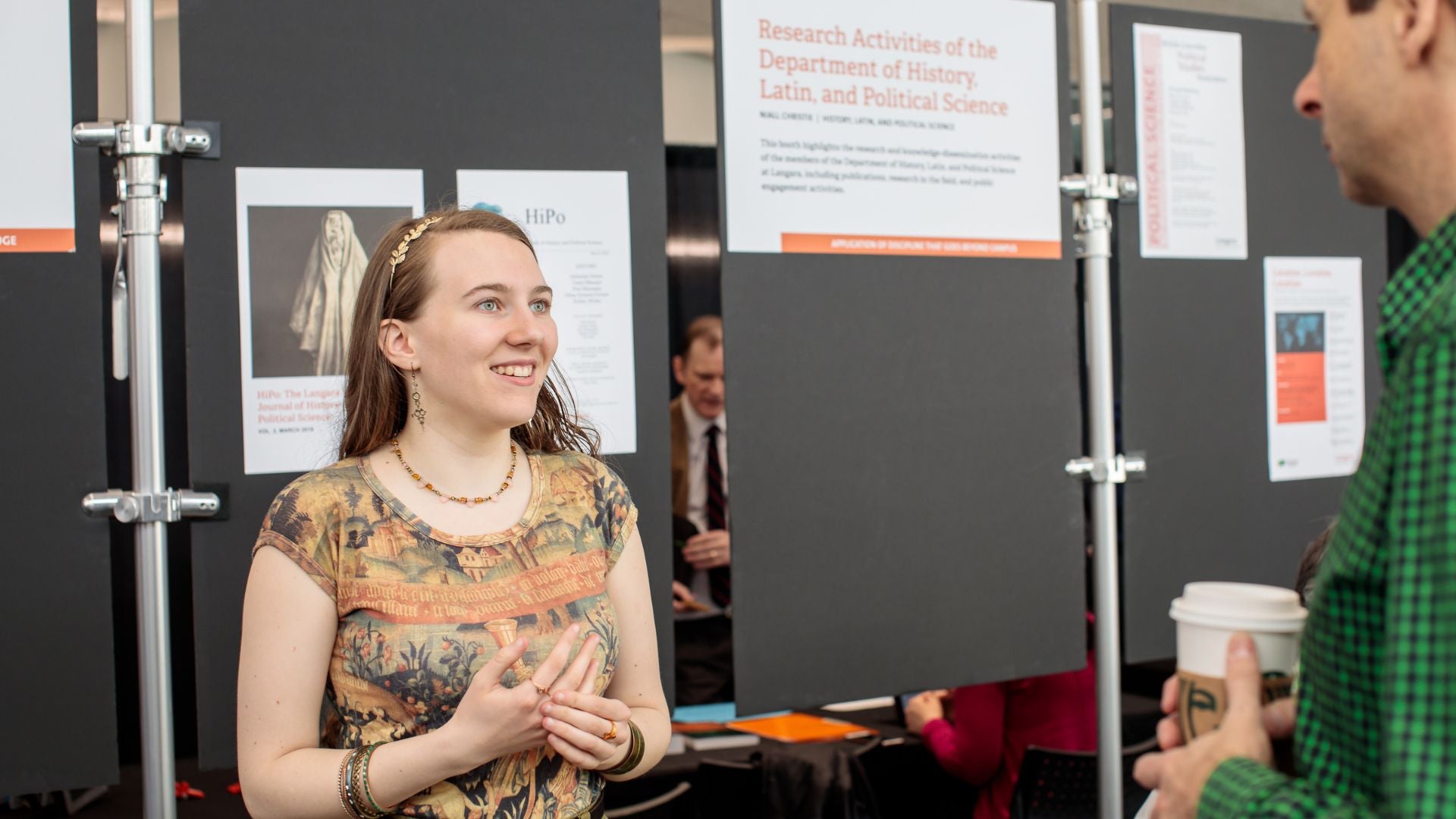 Nina Houle answers a question while displaying her research.