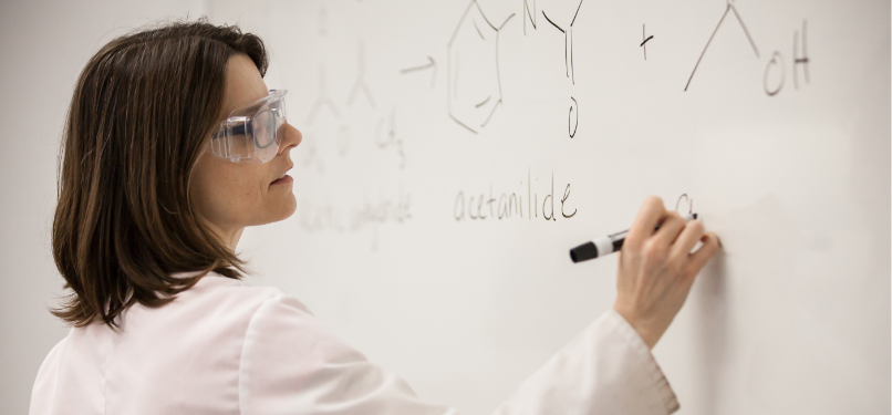 Instructor writing on a whiteboard
