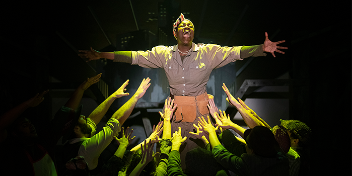Ivy Charles performing in Urinetown