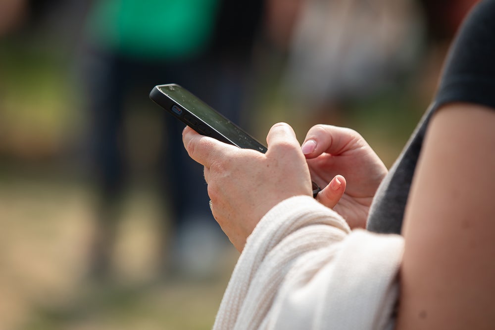 Student typing on phone