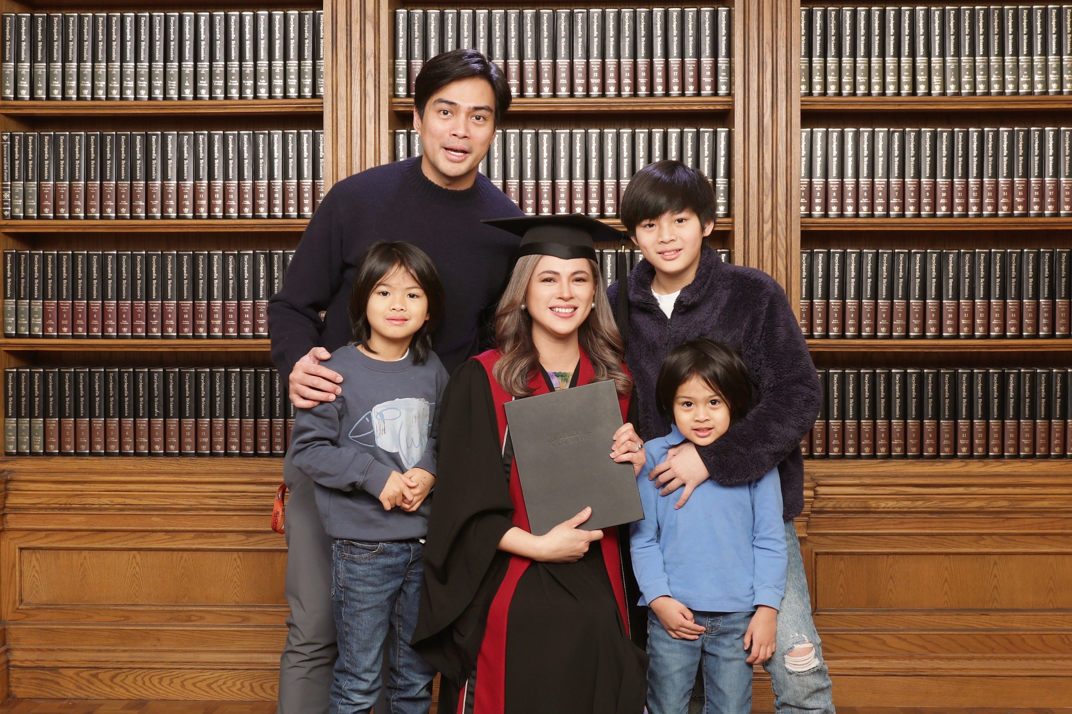 Langara ECE graduate Lara Quigaman with her family in a graduation portrait.