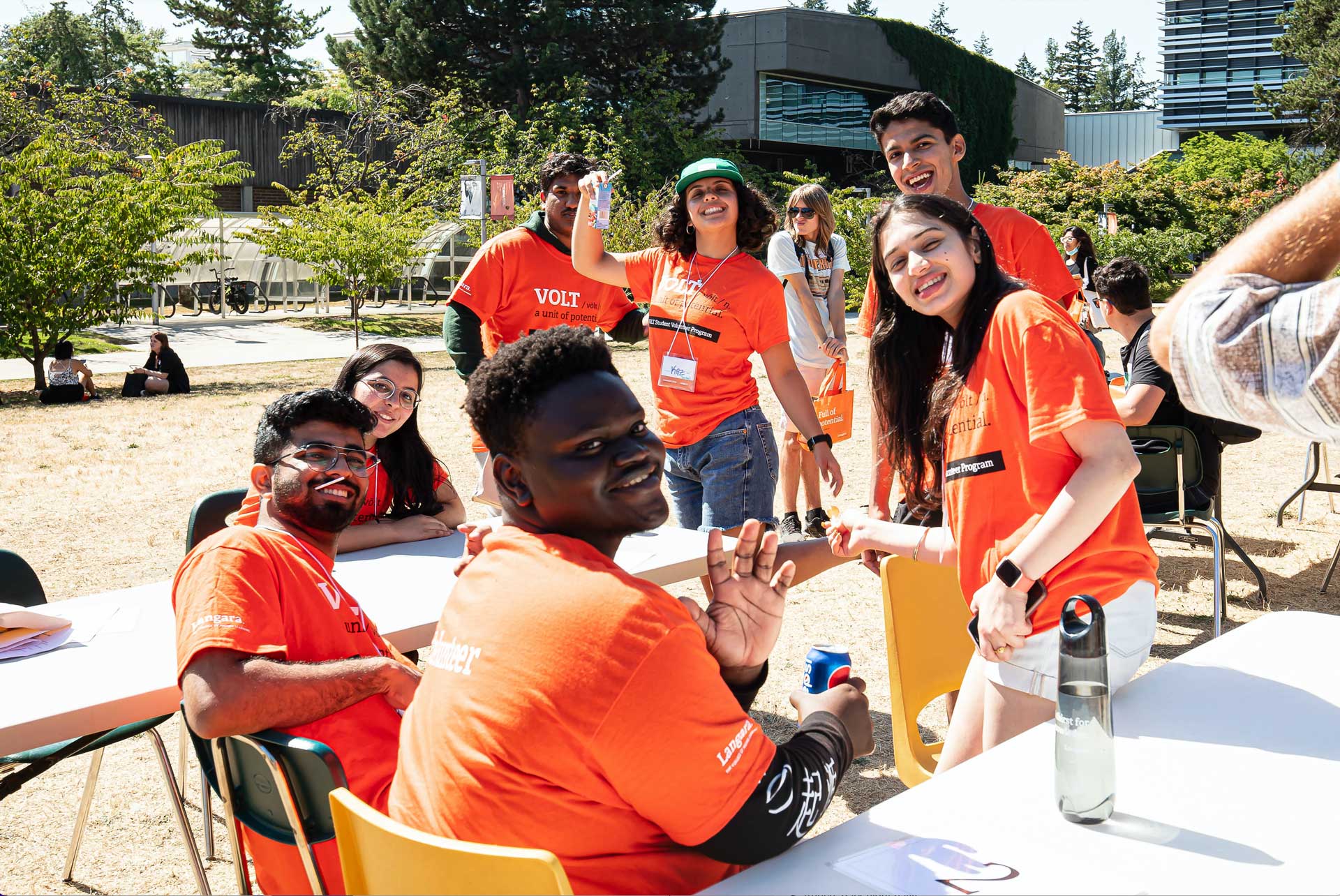 Volt volunteers in orange shirts on main campus.