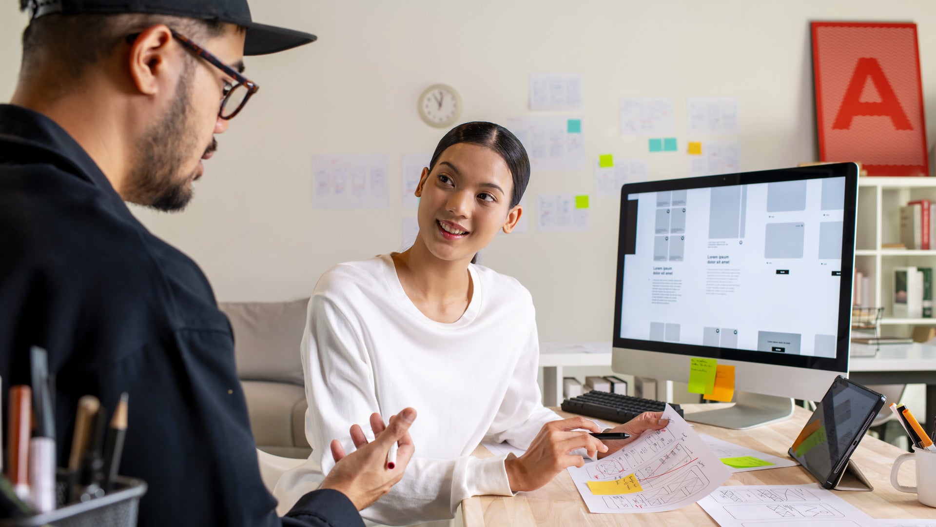 Two designers working together at a computer.
