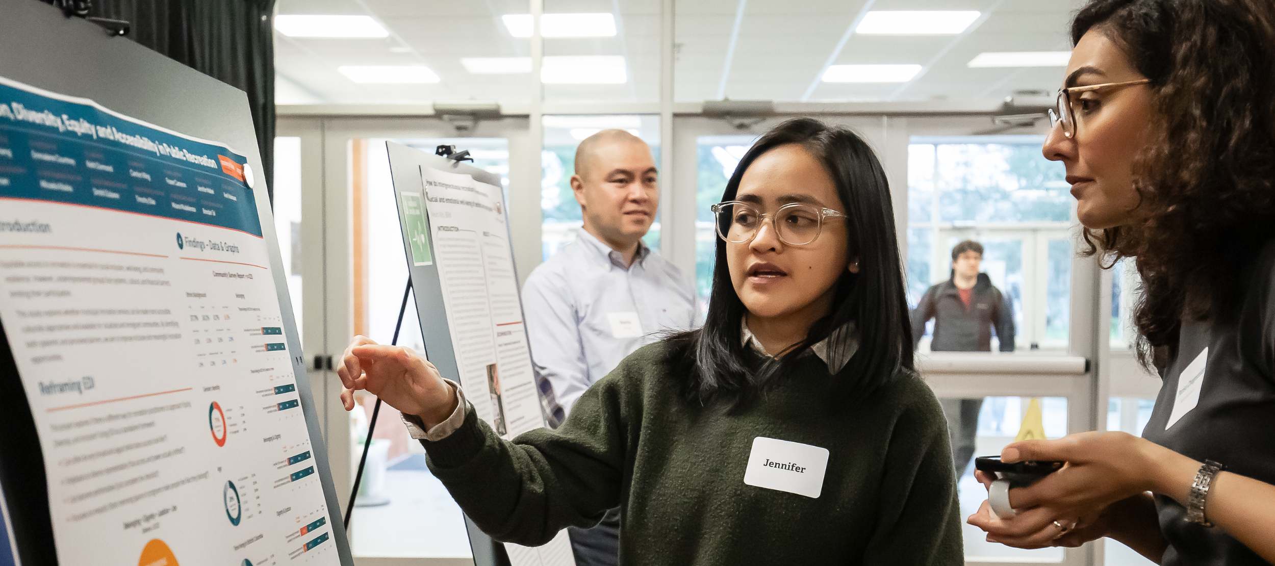 Junior Research Assistant, Jennifer Mallari, explains the IDEAs project at Applied Research Day, March 2026.
