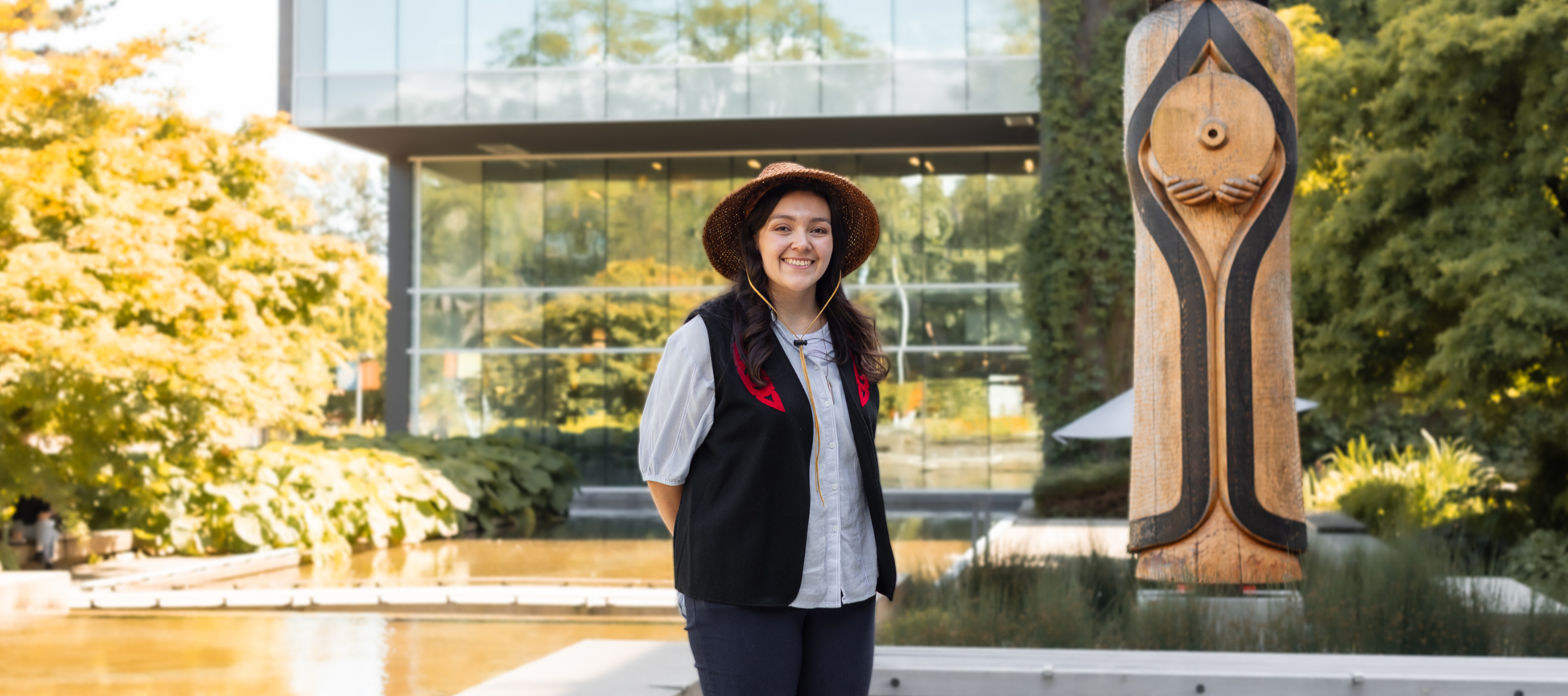 Langara alum, Amber Cornick, in front of the House Post and Library.