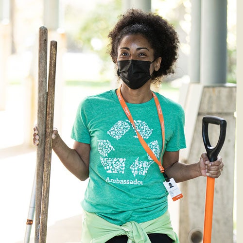 A volunteer is ready to make a difference by planting for a greener future.