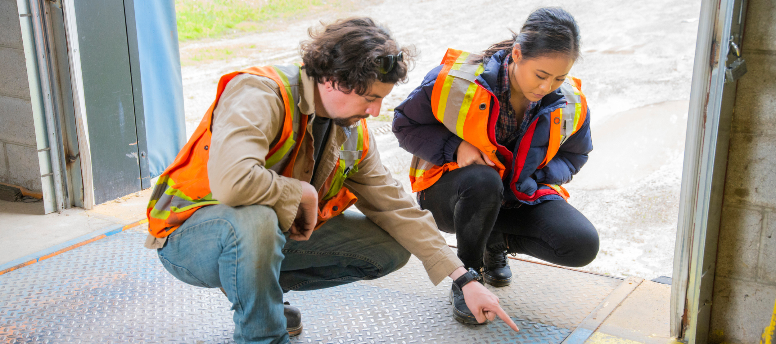 Stock image of two occupational health and safety officials analyzing a potential hazard.