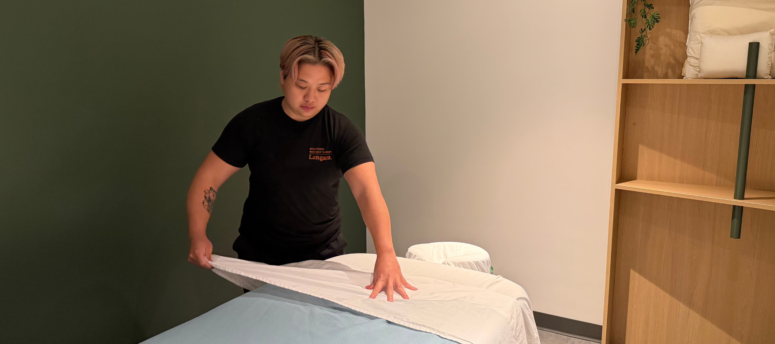 Second-year RMT student, Beverly Cheung, preparing a treatment room for client care in Langara College's new RMT student clinic.