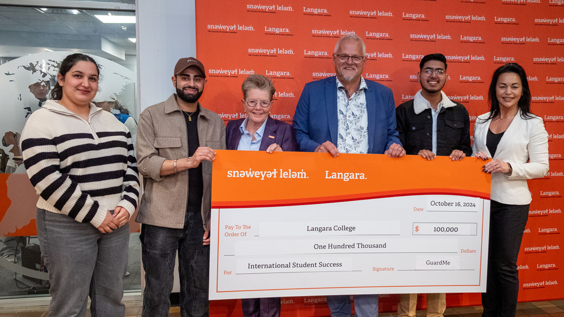 Students and Langara President receive a cheque from GuardMe