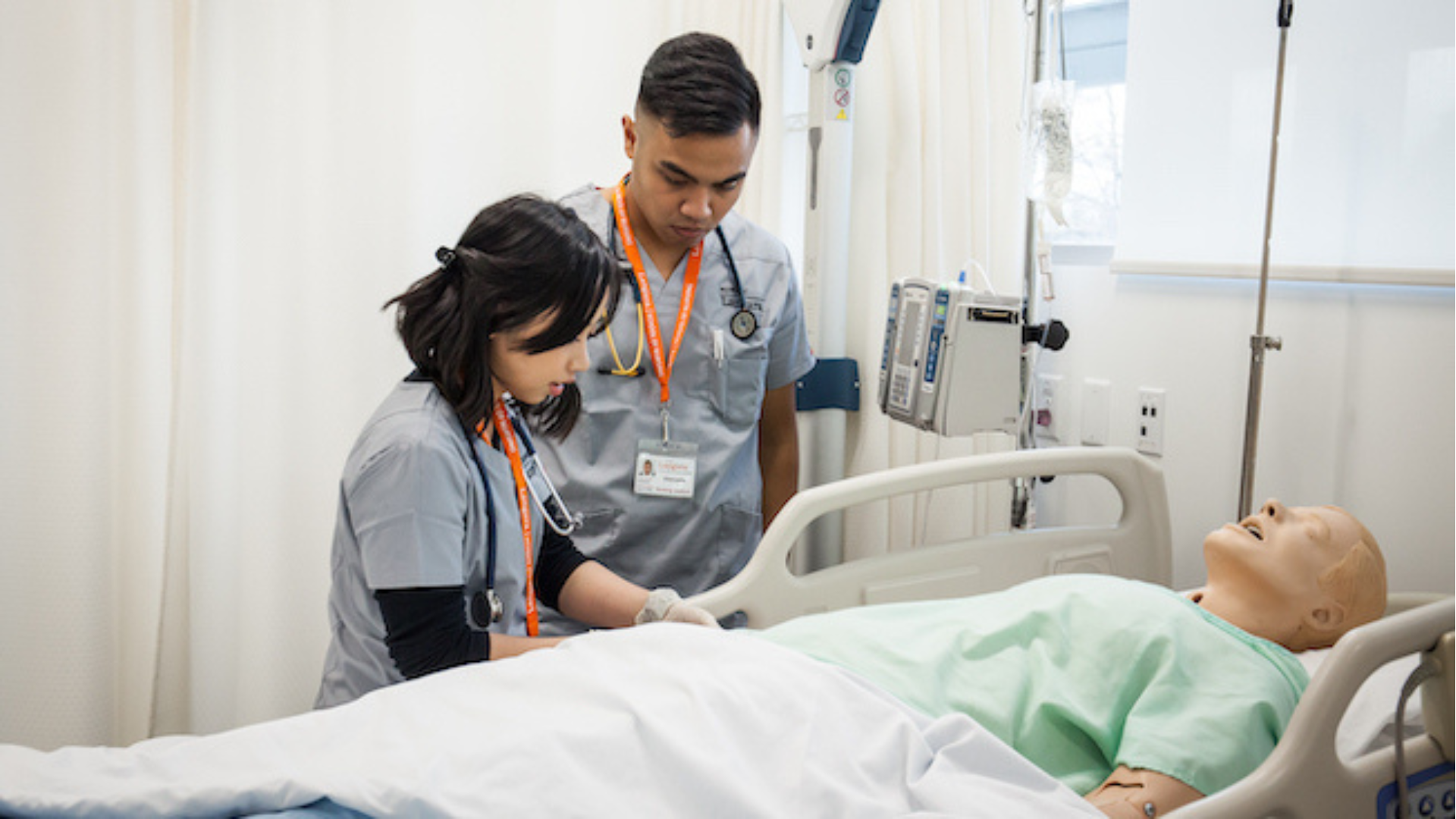 Nursing students working on a medical mannequin in the simulation lab.