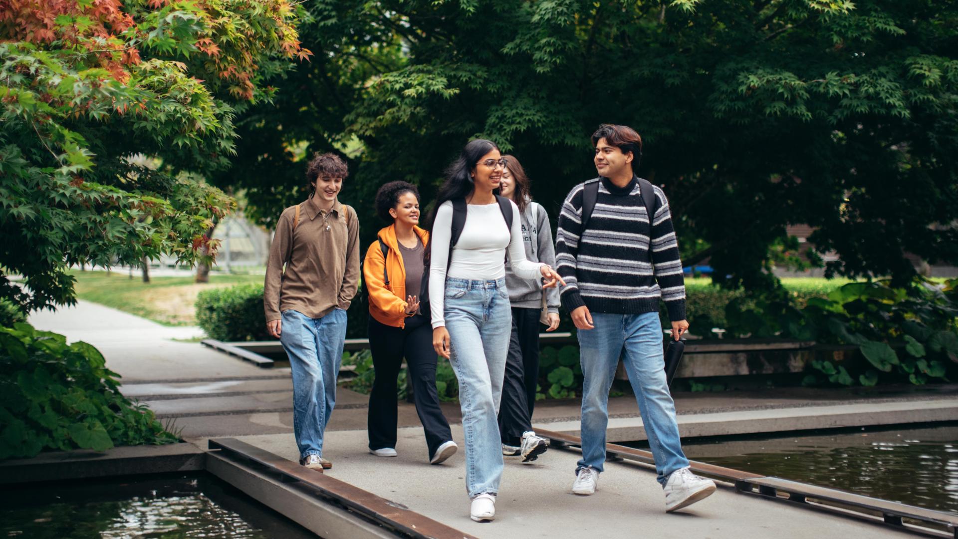 Students crossing the campus pond.