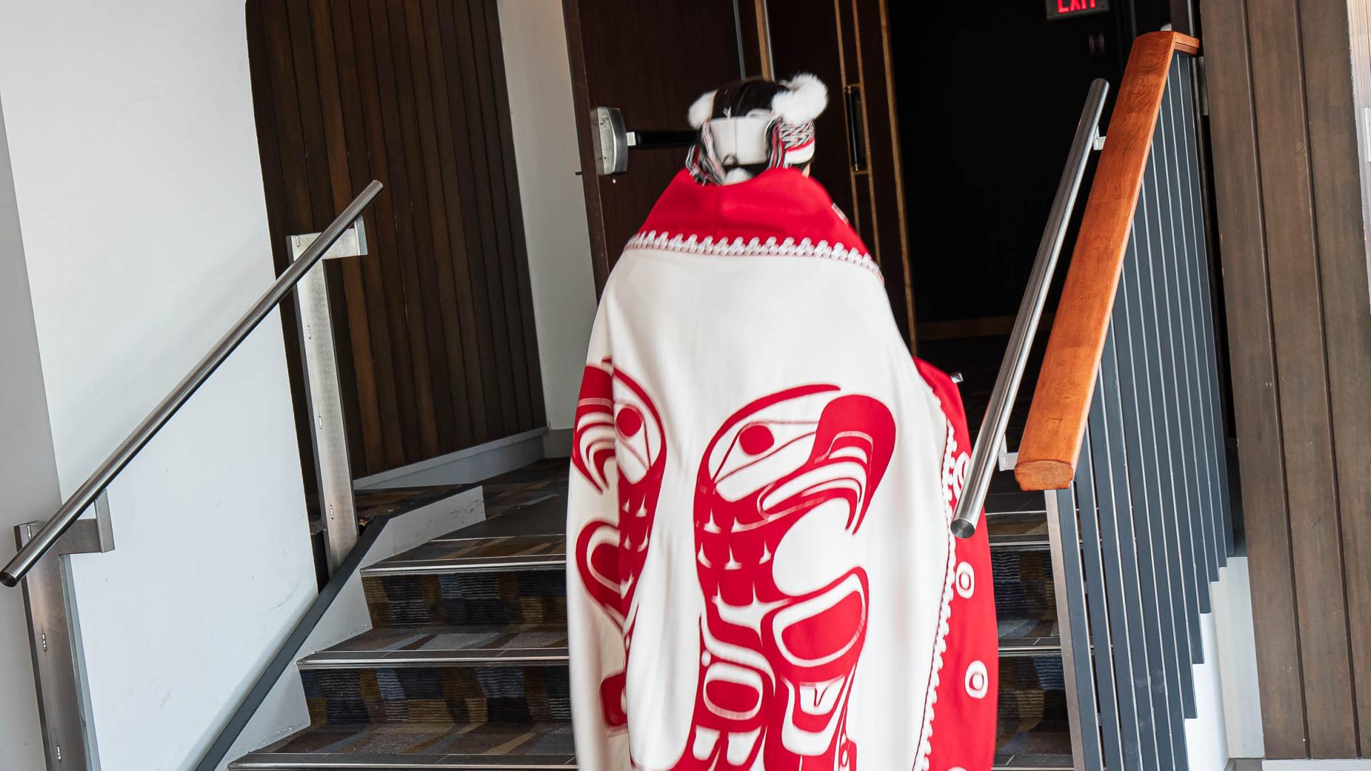 An Indigenous design stitched into traditional attire worn by a graduating student.