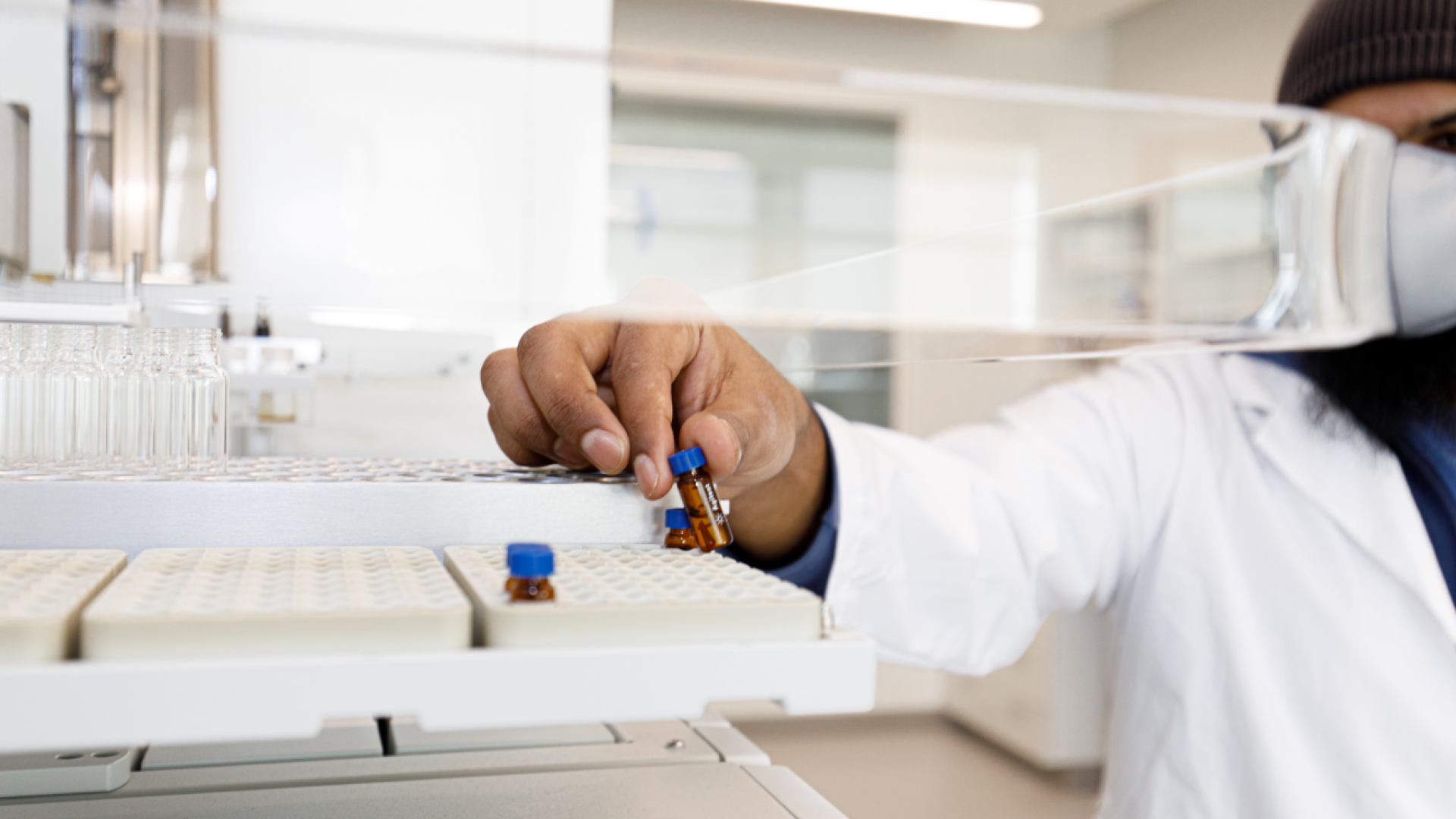 Chemistry student holding small glass vial