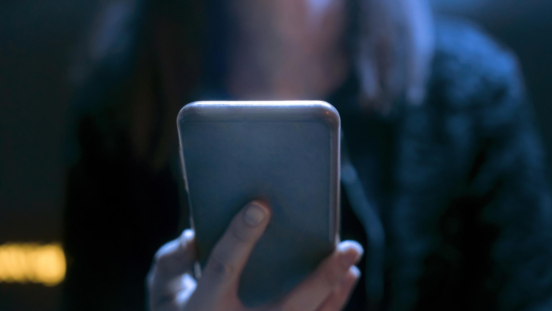 Person using a phone in the dark