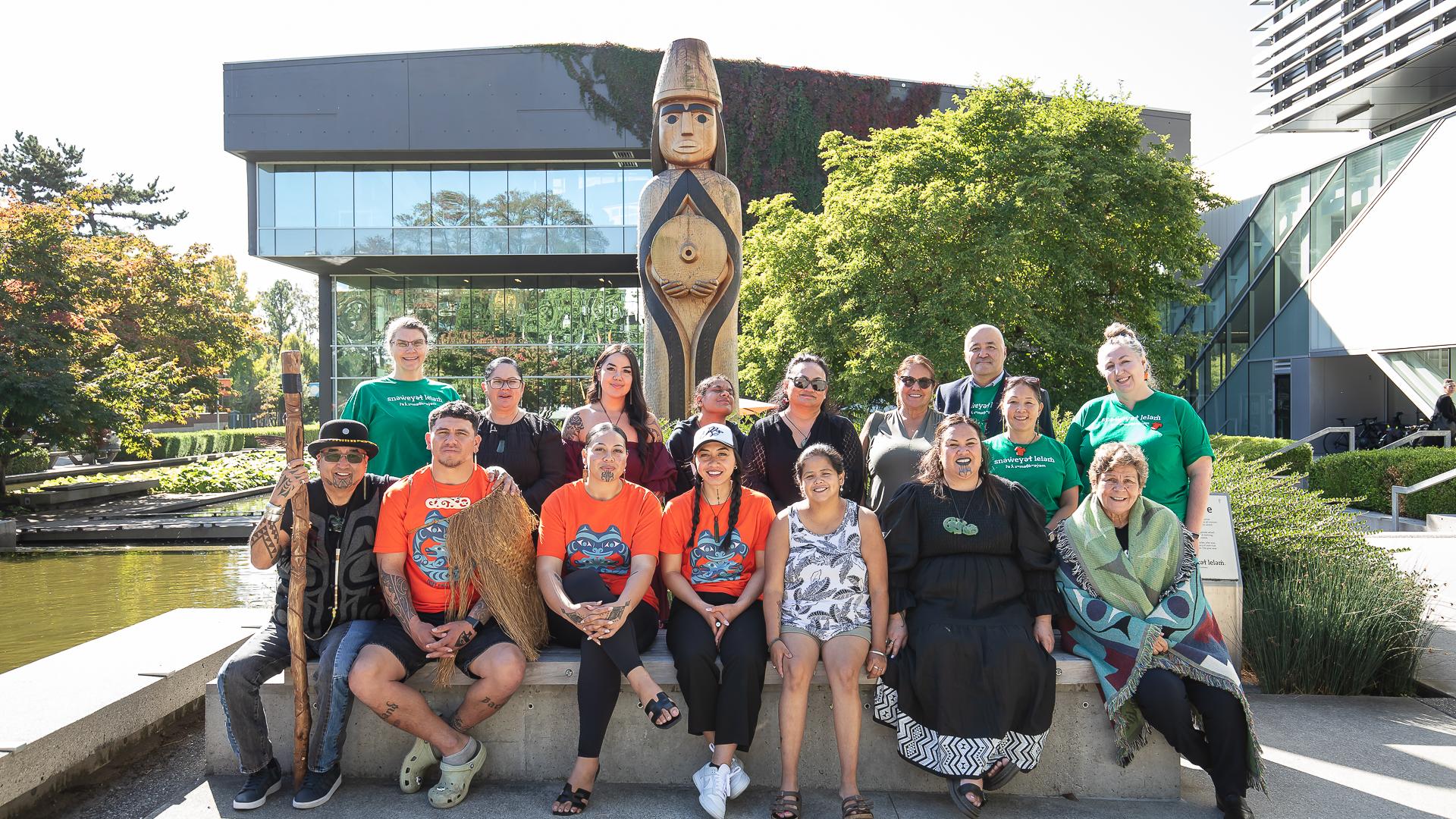 Members of Langara College's Indigenous Engagement and Initiatives team with Maori guests at the College's House Post, gifted by Musqueam.