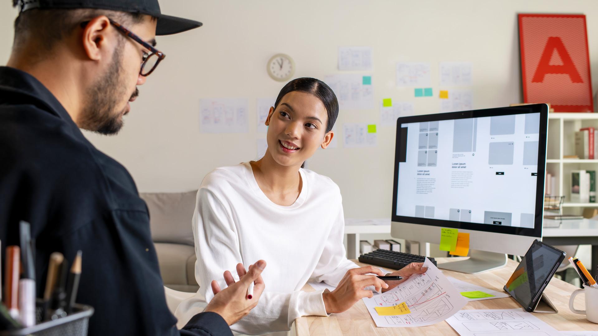 Two designers working together at a computer.