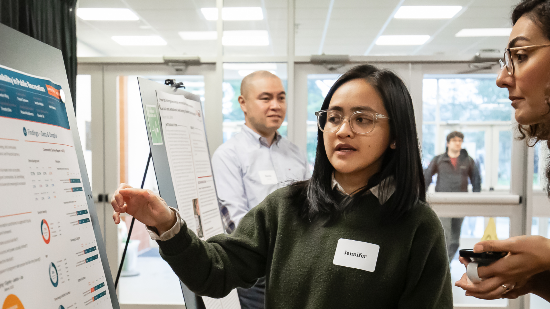 Junior Research Assistant, Jennifer Mallari, explains the IDEAs project at Applied Research Day, March 2026.