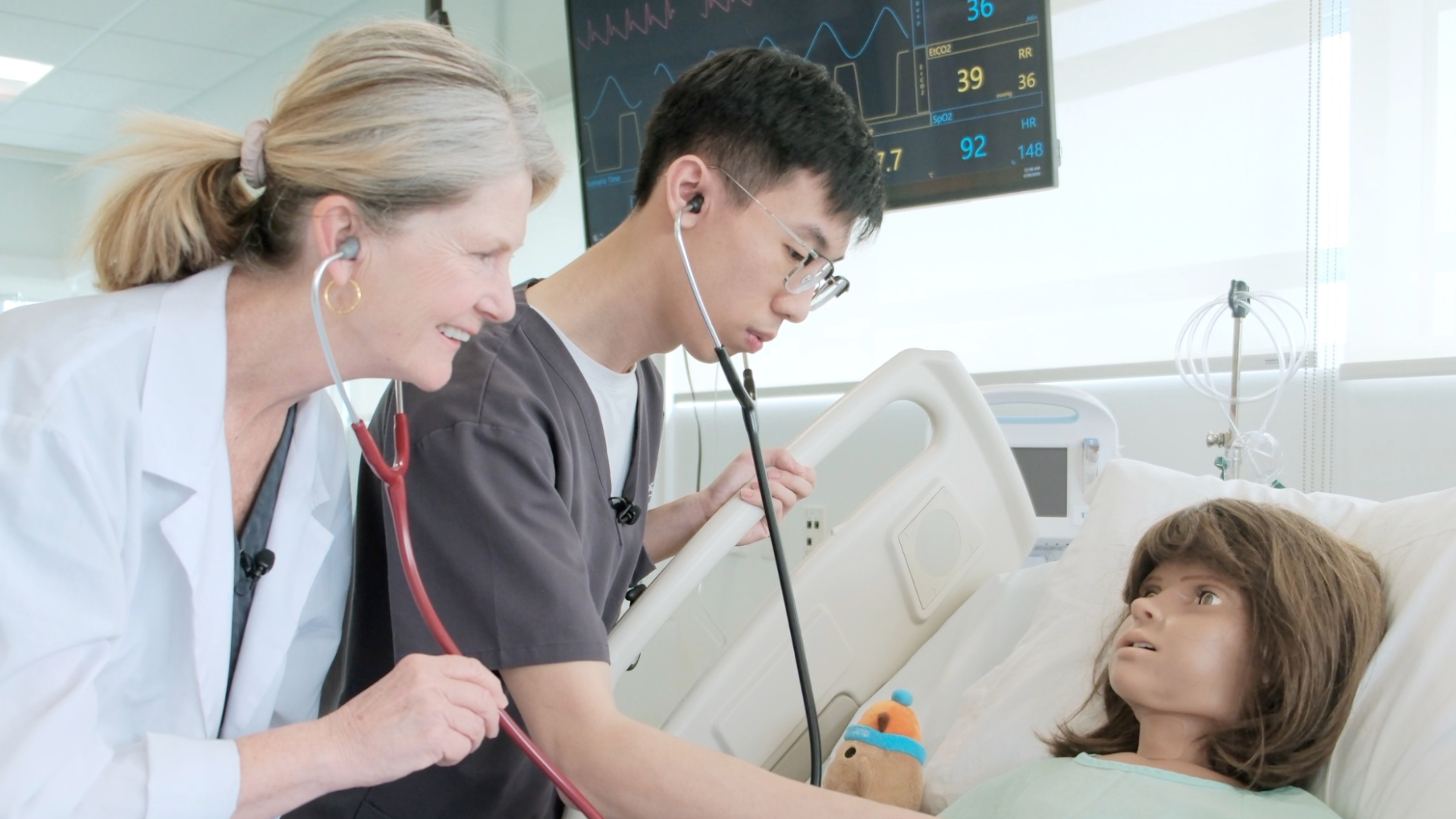 Nursing student, Tim Pham, and instructor, Mary Peters, working with a high-fidelity mannequin in a simulated care scenario.