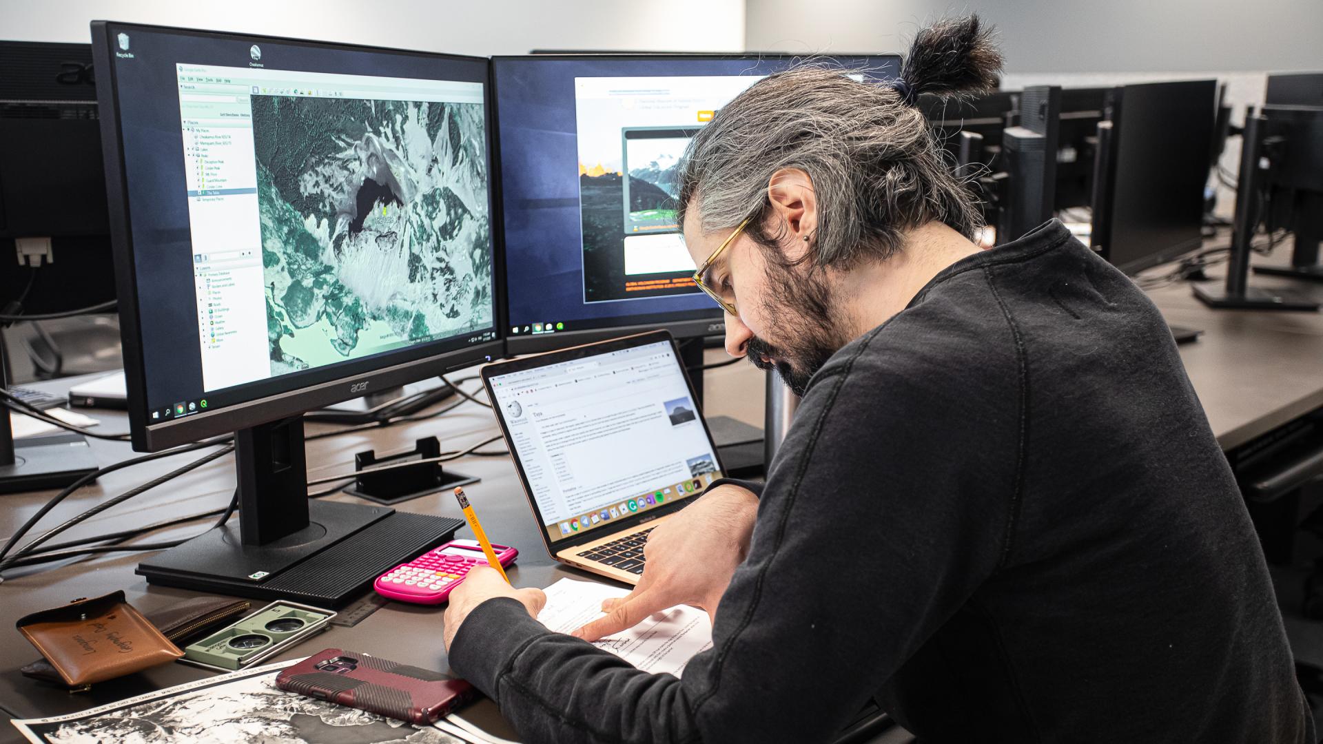 Student sitting at a computer working on an applied planning assignment.