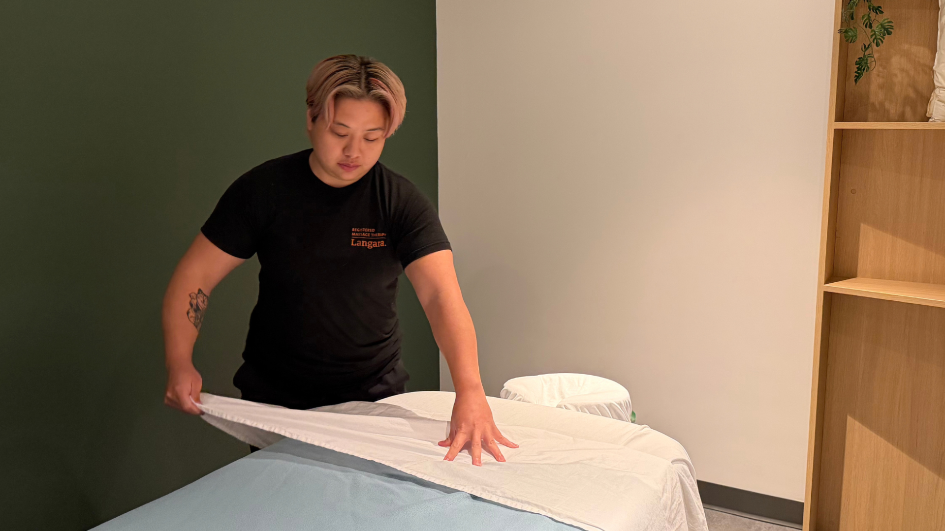 Second-year RMT student, Beverly Cheung, preparing a treatment room for client care in Langara College's new RMT student clinic.