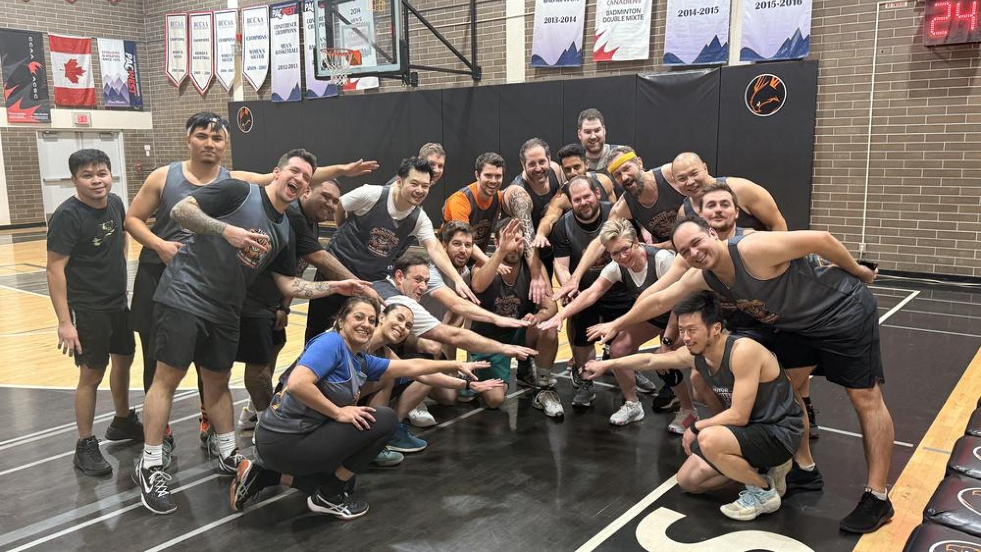 Students and Langara staff pose together after the charity basketball game