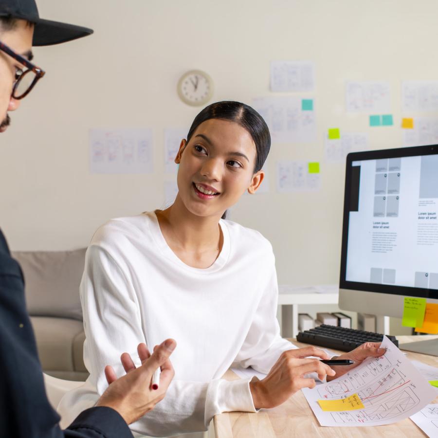 Two designers working together at a computer.