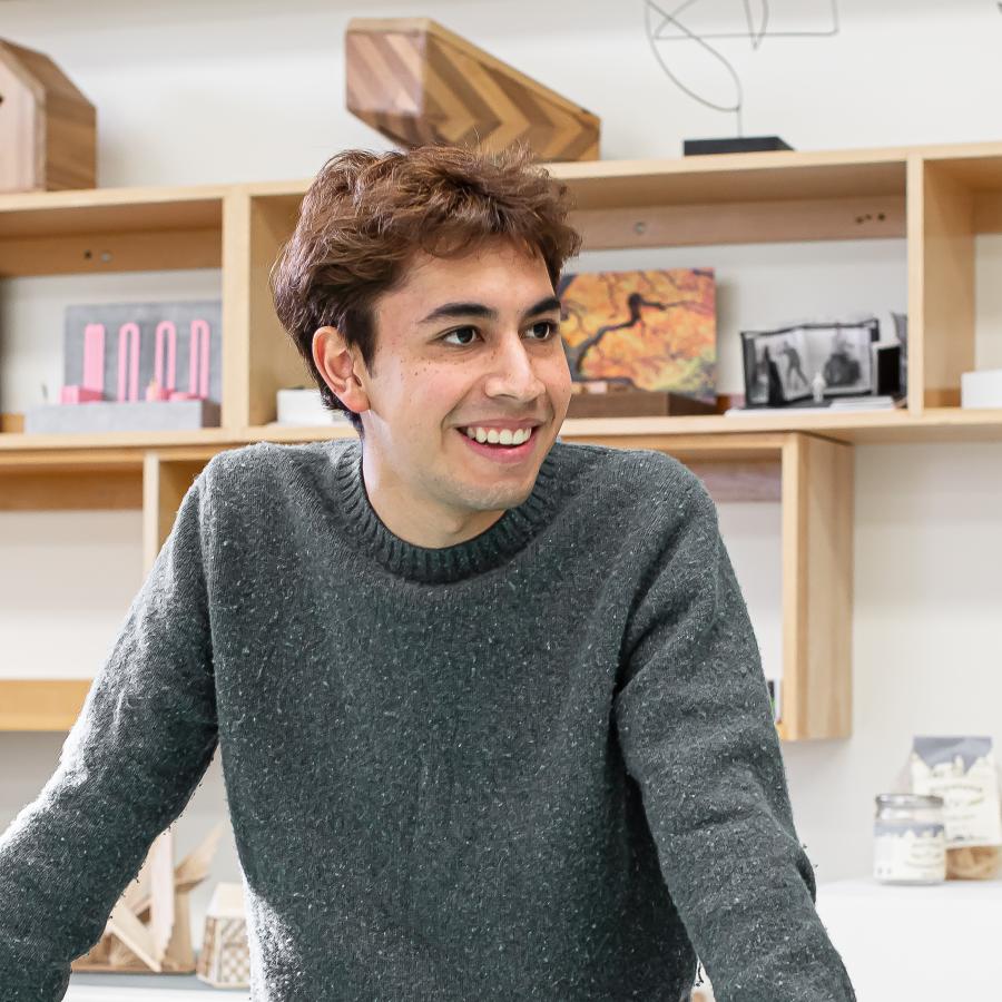 Jorge Rebollo Sandoval standing and smiling in Langara's Design Formation studio.