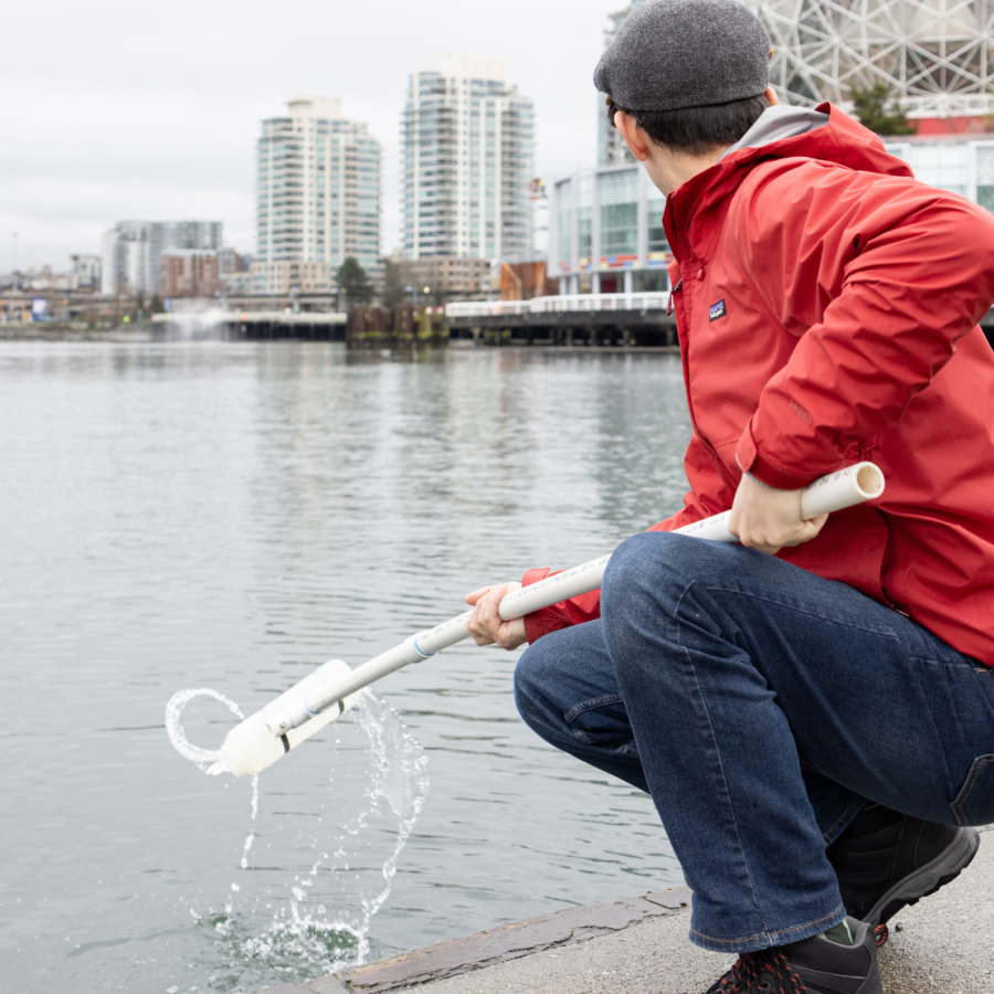Instructor Kevin Rey collecting water and marine life samples in False Creek.