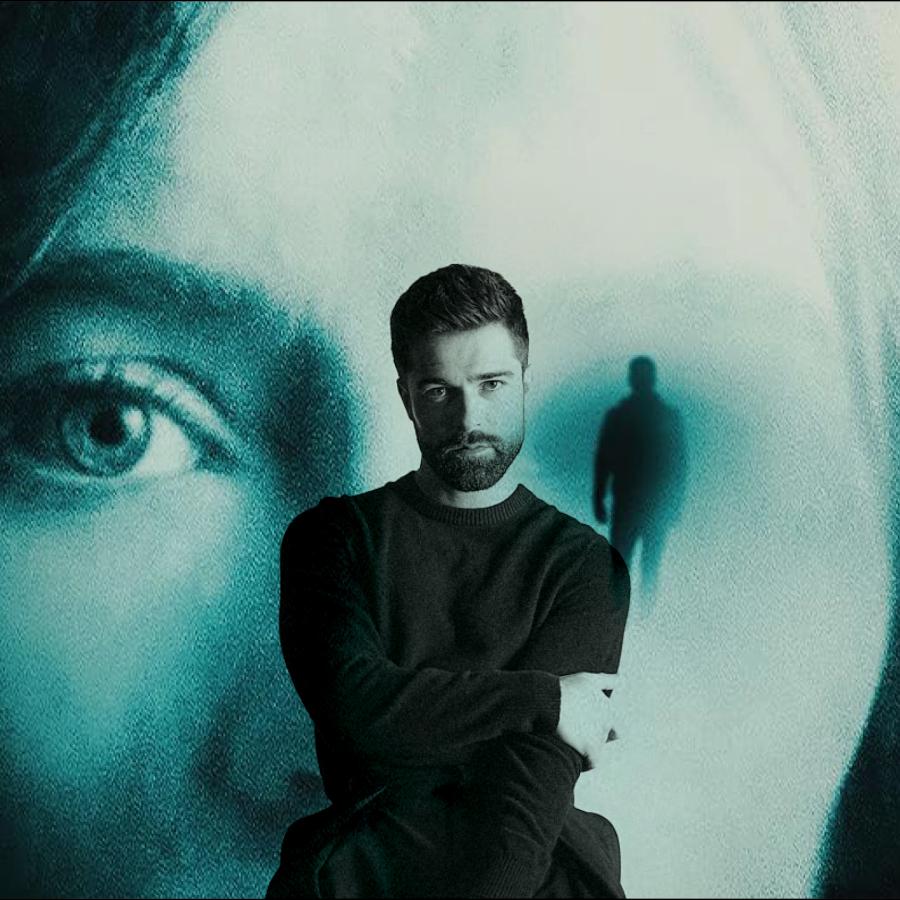 Studio 58 alum, Markian Tarasiuk, in the foreground with the poster of his movie in the background.