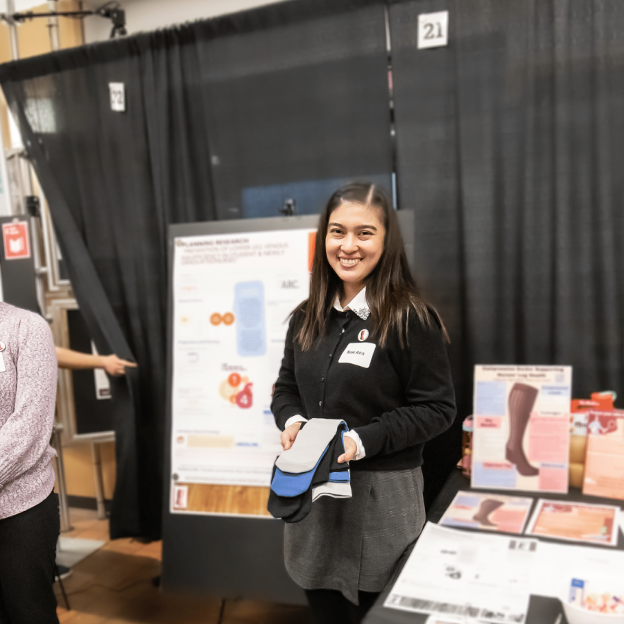Nursing students smiling at their booth presenting their project at Applied Research Day 2026.