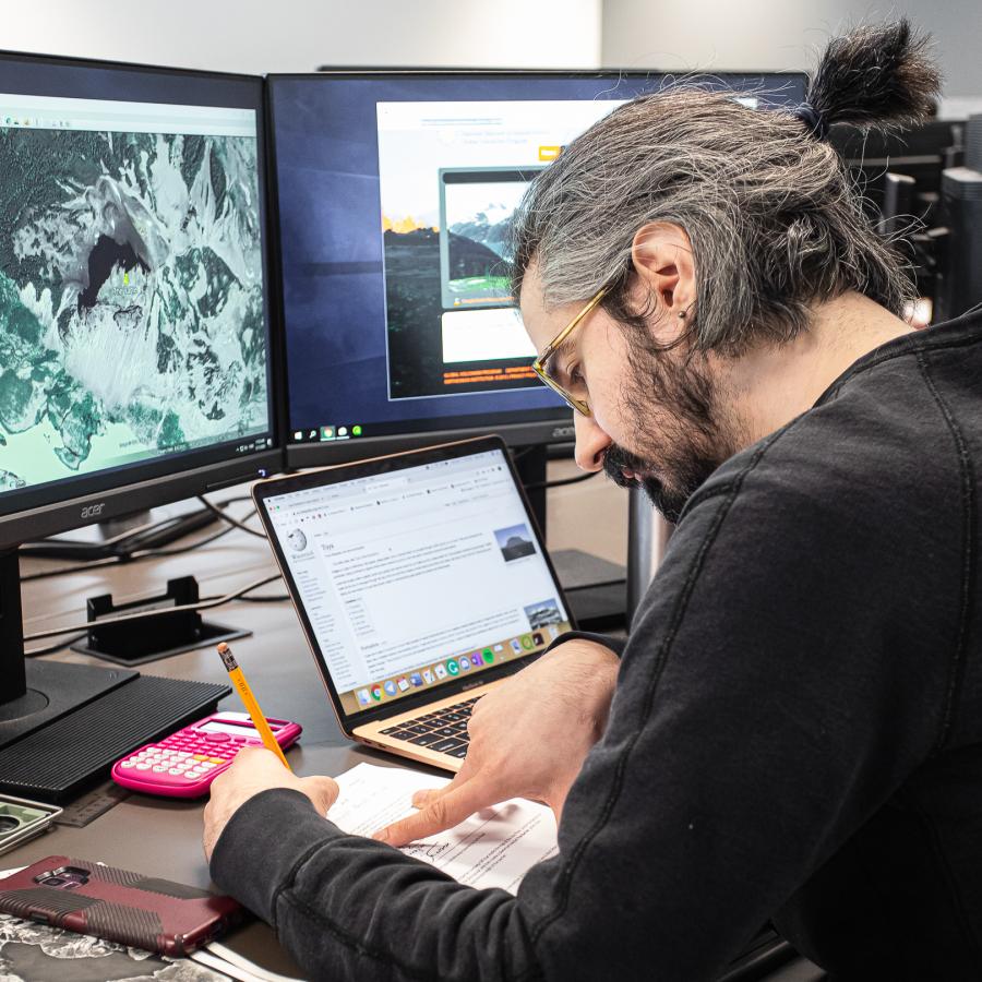 Student sitting at a computer working on an applied planning assignment.