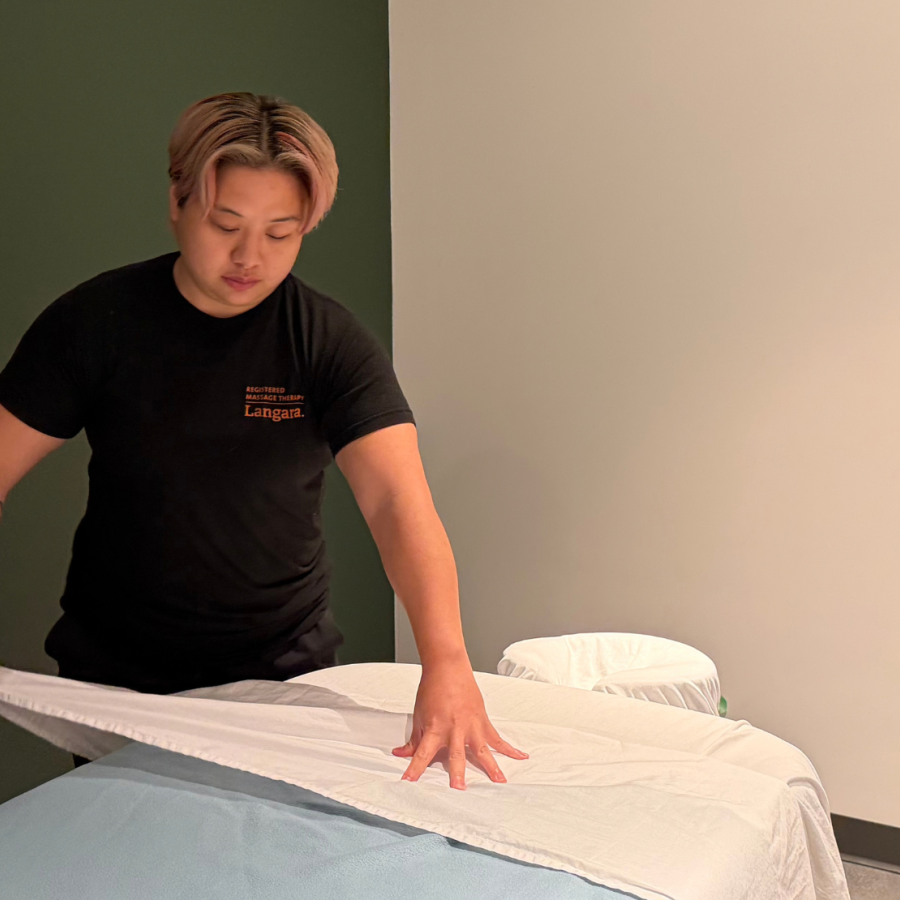 Second-year RMT student, Beverly Cheung, preparing a treatment room for client care in Langara College's new RMT student clinic.