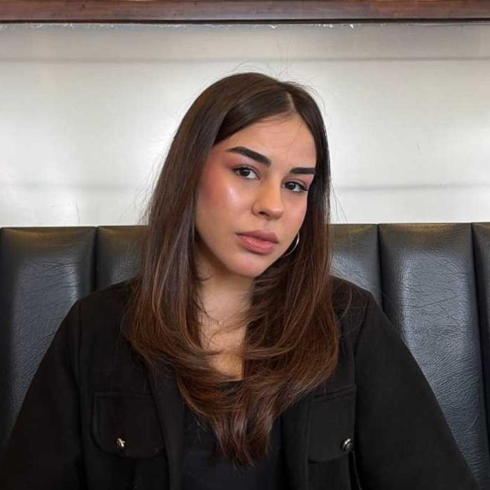Female student portrait wearing black clothing, facing the camera with a neutral expression.