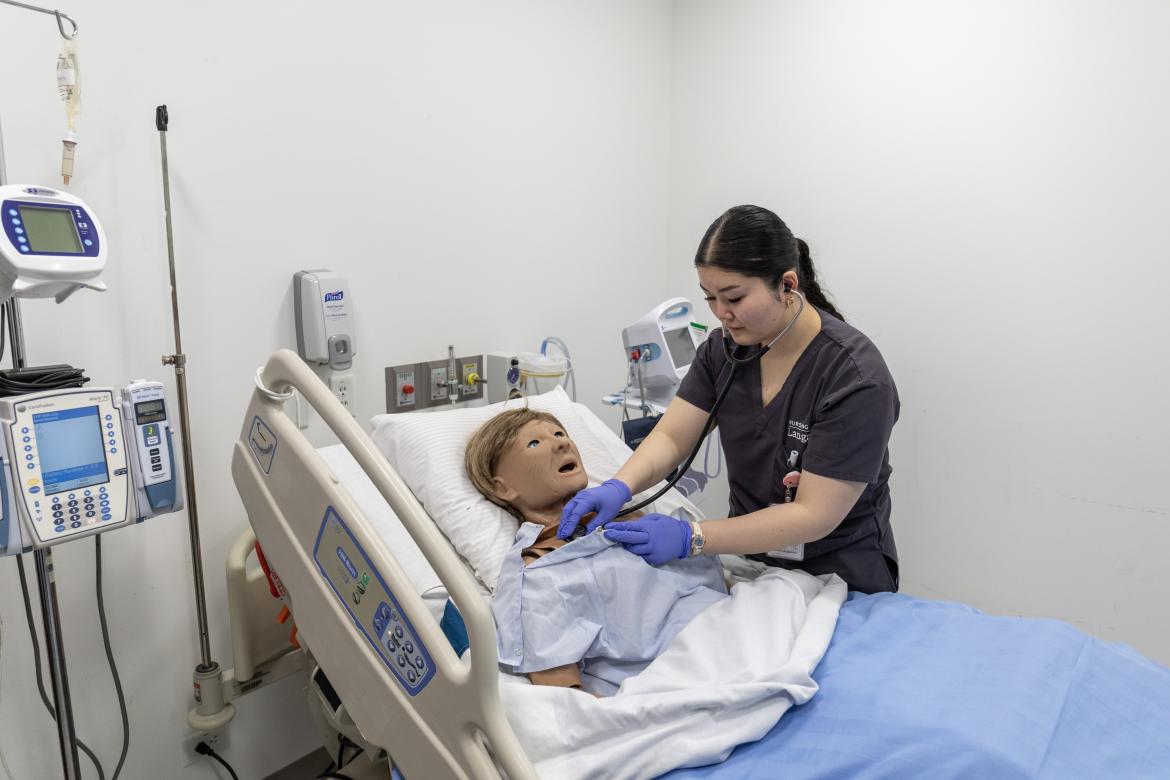 Nursing student Marcelyn Bacomo trains on a nursing doll.