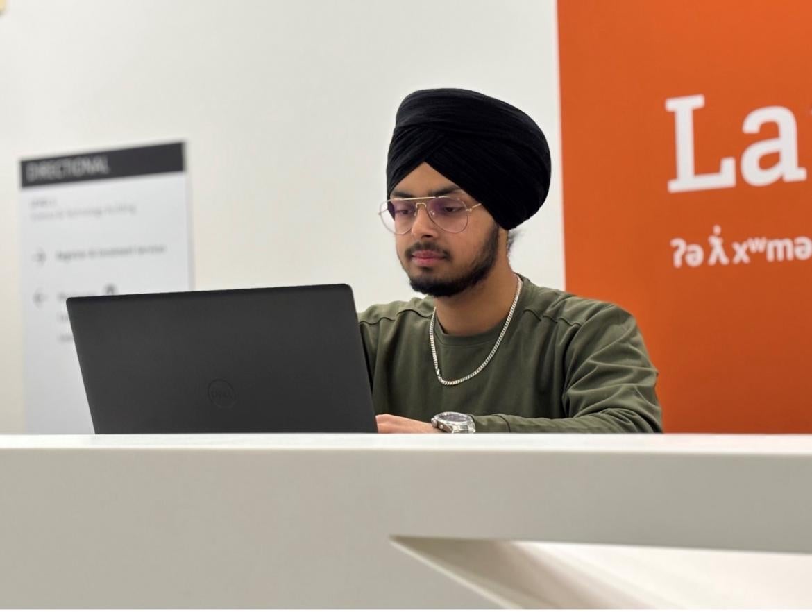 Student Onkar Bhullar working on his laptop.