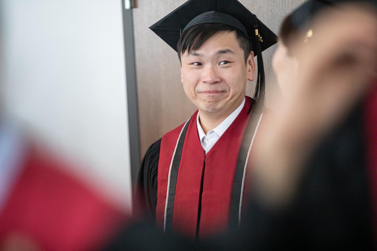A student is filled with emotion at graduation.