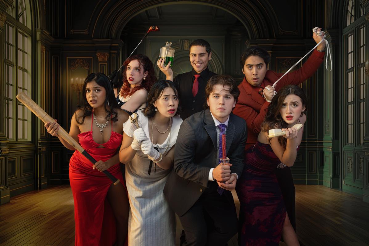 The grad class of Fall 2025 dressed up as clue characters, holding various weapons.