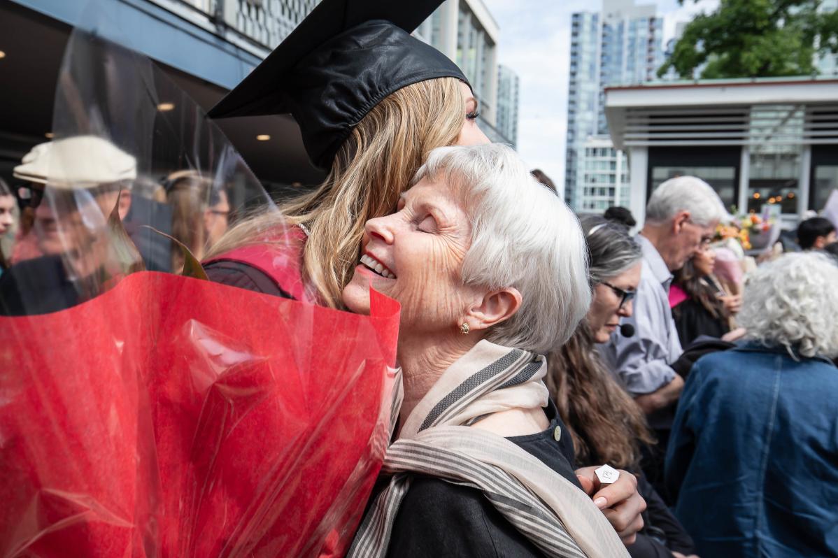 Guest hugs graduate at Langara Convocation