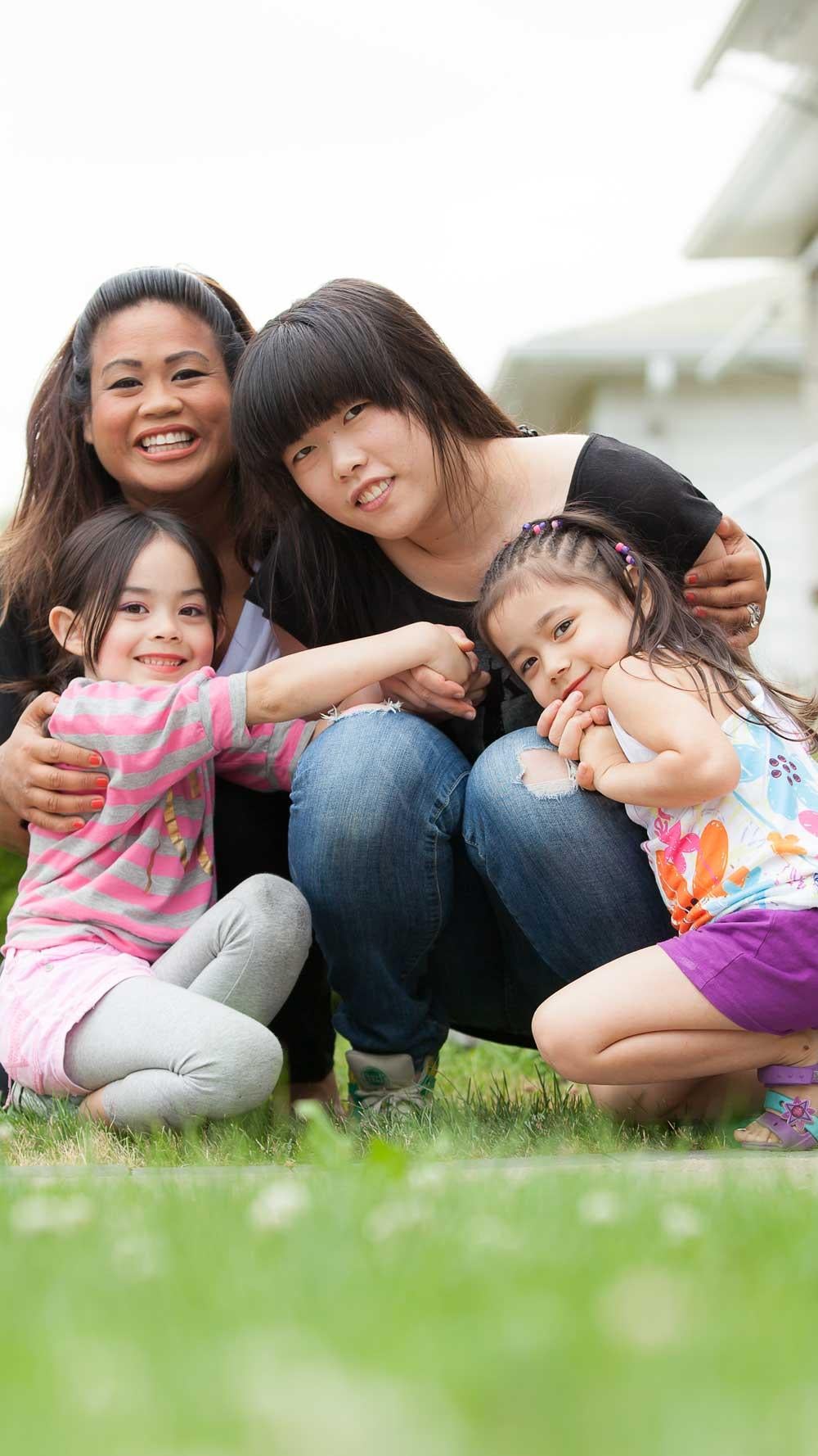 Homestay family hugging their student outdoors.