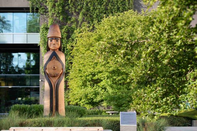 The carved cedar house post figure welcomes visitors to Musqueam territory