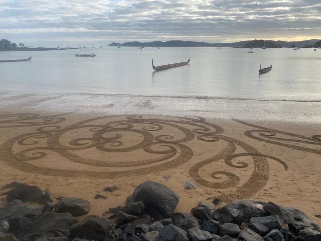 Māori longboats and beach markings on Waitangi Day.