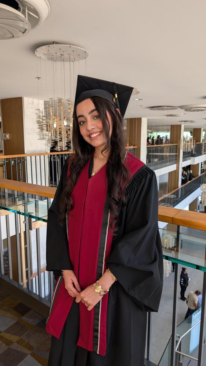 Khushi Salwan wearing her convocation regalia at Queen Elizabeth Theatre.