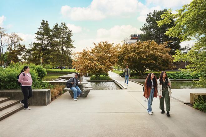 Students walking near the reflective pond at Langara College's campus located in the heart of Vancouver, British Columbia, Canada.